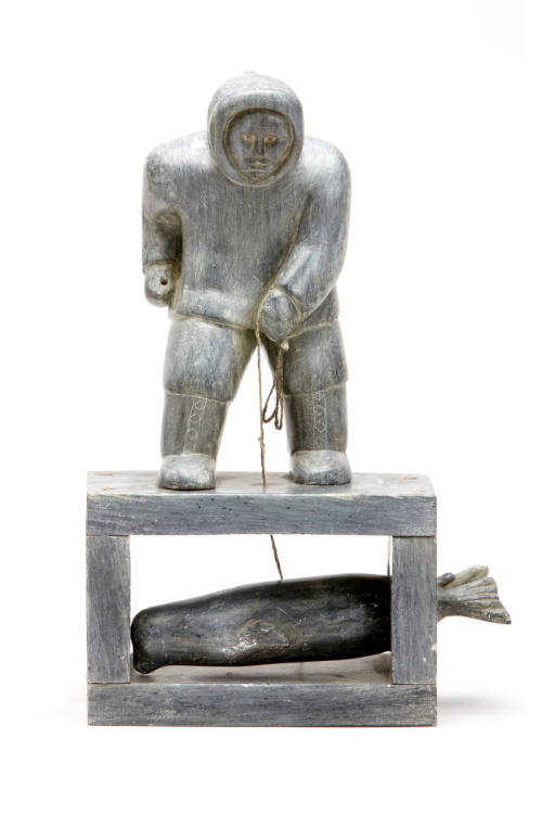 Hunter with Captured Seal Under the Ice
